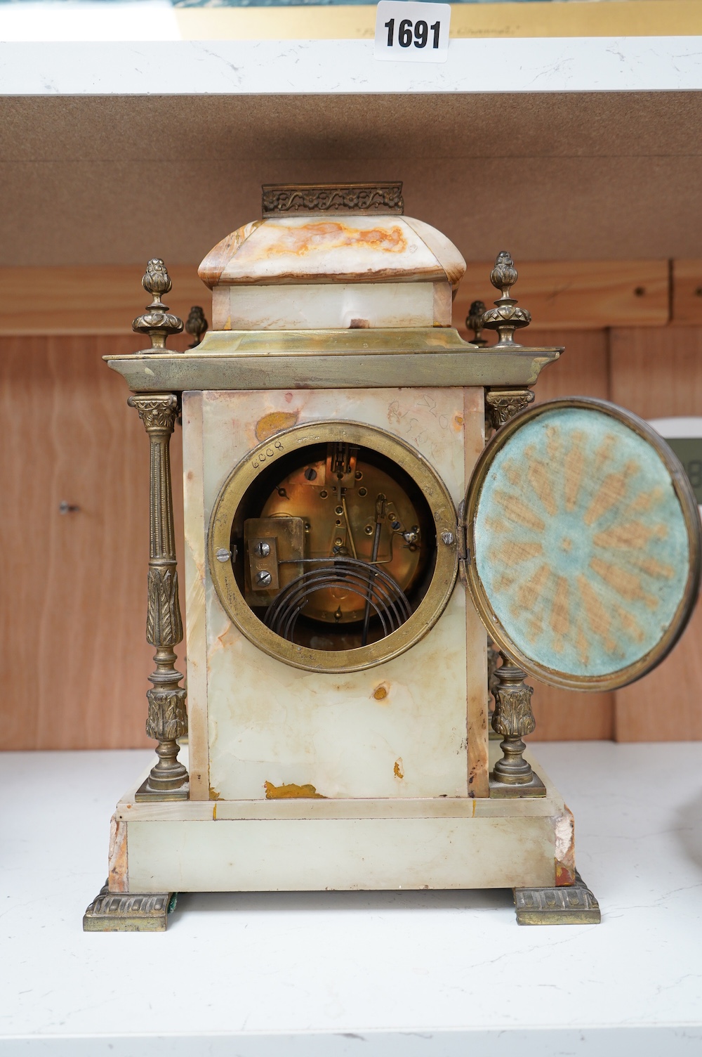 An early 20th century marble and onyx mantel clock with enamel dial with pendulum, no key, 32cm high. Condition - fair, untested